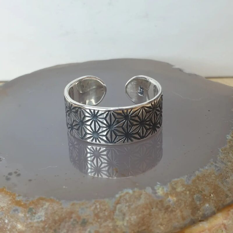 a pair of sterling silver wedding rings, etched with sacred geometry Asanoha pattern