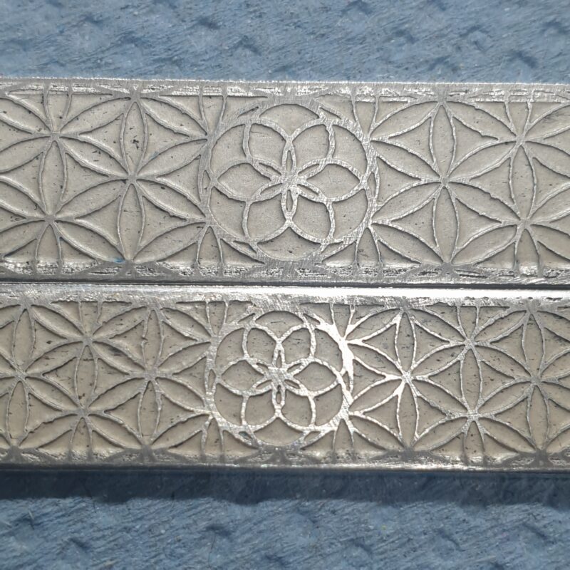Etched flower of life design on wedding rings